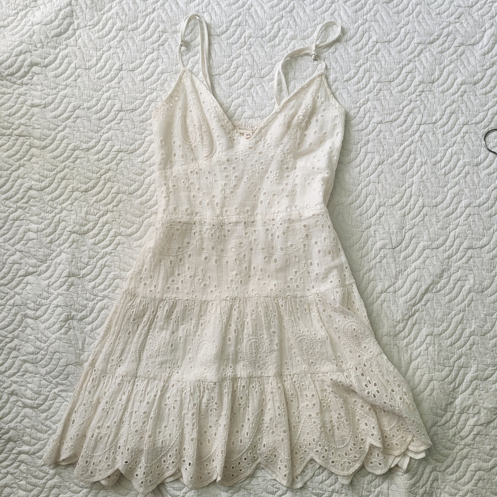 white cotton summer mini dress with embroidered eyelet pattern